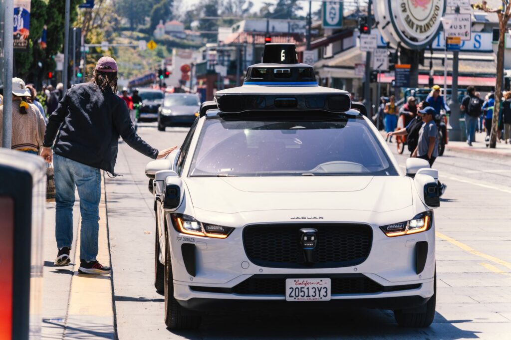 A self-driving car navigating a busy San Francisco city street